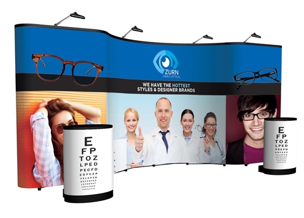 Finished 20ft Coyote curved trade show display with a full-height graphic wall and two counters